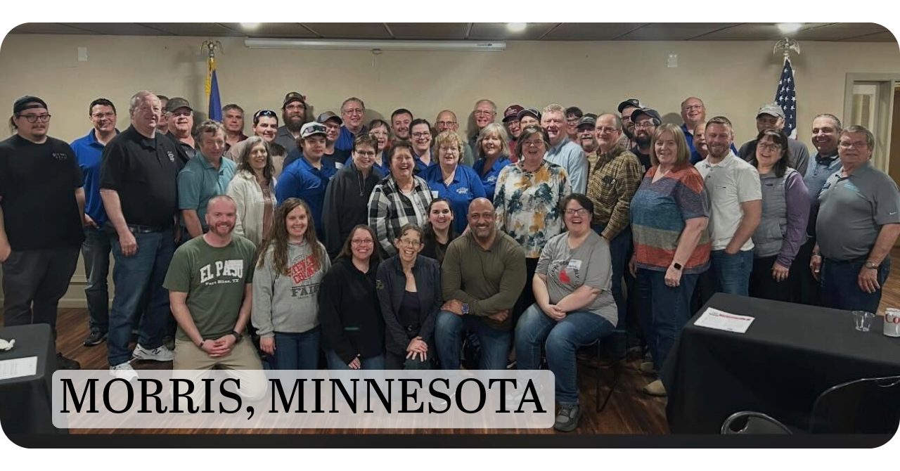 Large group of community members gathered indoors for a group photo in Morris, Minnesota, participating in the You Make THE Difference state initiative.
