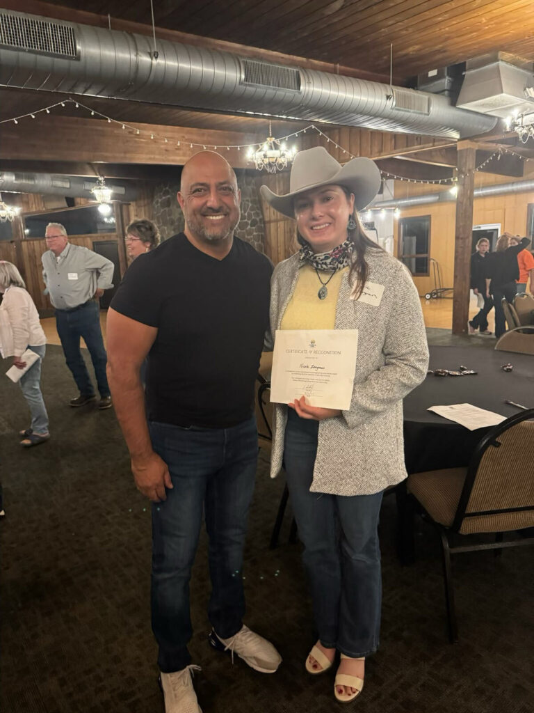 Ian Hill with an Empowering Minds participant holding a certificate of recognition.